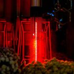 Glowing red outdoor patio gas heater warming a terrace on a cool Dubai evening